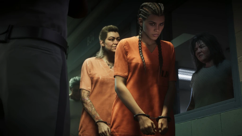 Lucia i orange fångdräkt och handbojor leds genom en fängelsekorridor i Grand Theft Auto VI, följd av en annan intagen med tatuerad arm.