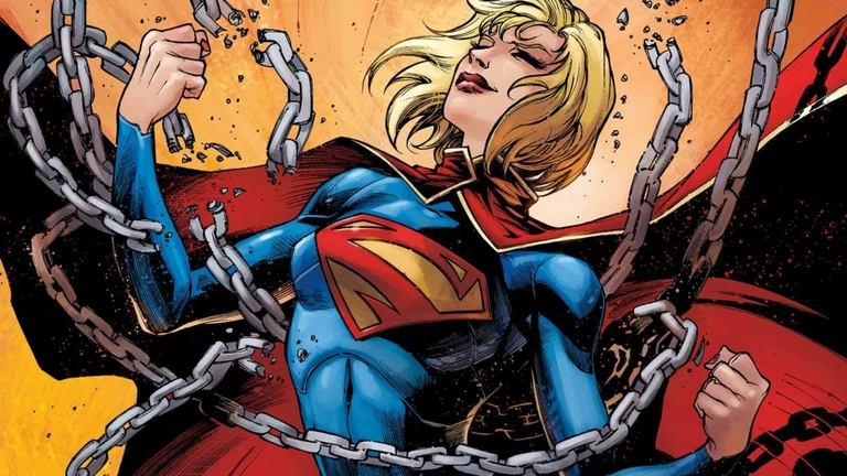 Supergirl med blont hår och röd cape spänner sig med slutna ögon och sprider sönder kedjor som hänger runt henne, i serietidningsstil.