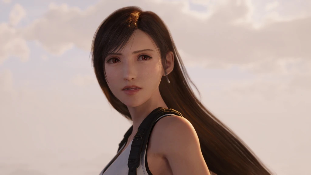 Tifa med långt mörkbrunt hår och allvarlig blick mot en dis himmel med moln, i en scen ur Final Fantasy VII: Revelations.