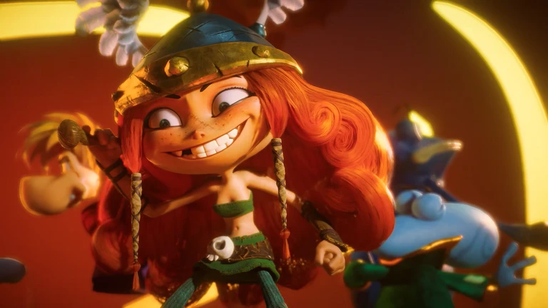 Den rödhåriga krigaren Barbara ler brett med en horngjord hjälm på huvudet, medan Rayman och Globox skymtar bakom henne i en färgstark scen ur Rayman Legends Retold.