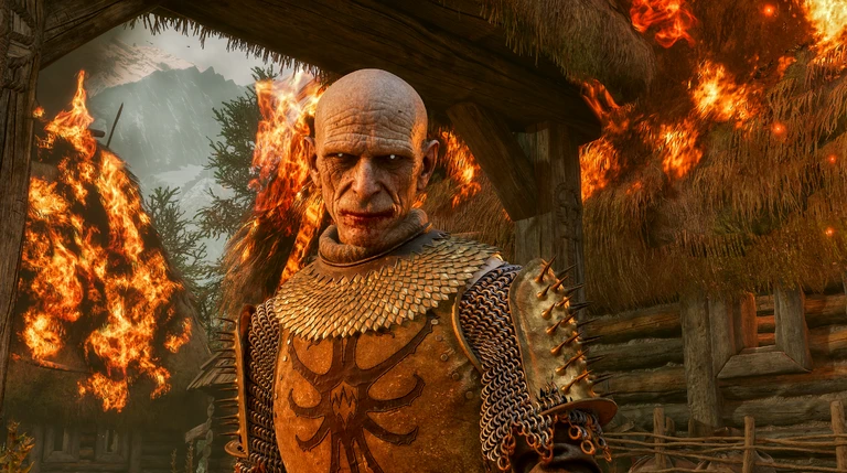 En skallig, ärrig man i fjällpansar och beslagen axelrustning står framför brinnande halmtäckta hus i en bergsby i The Blood of Dawnwalker.