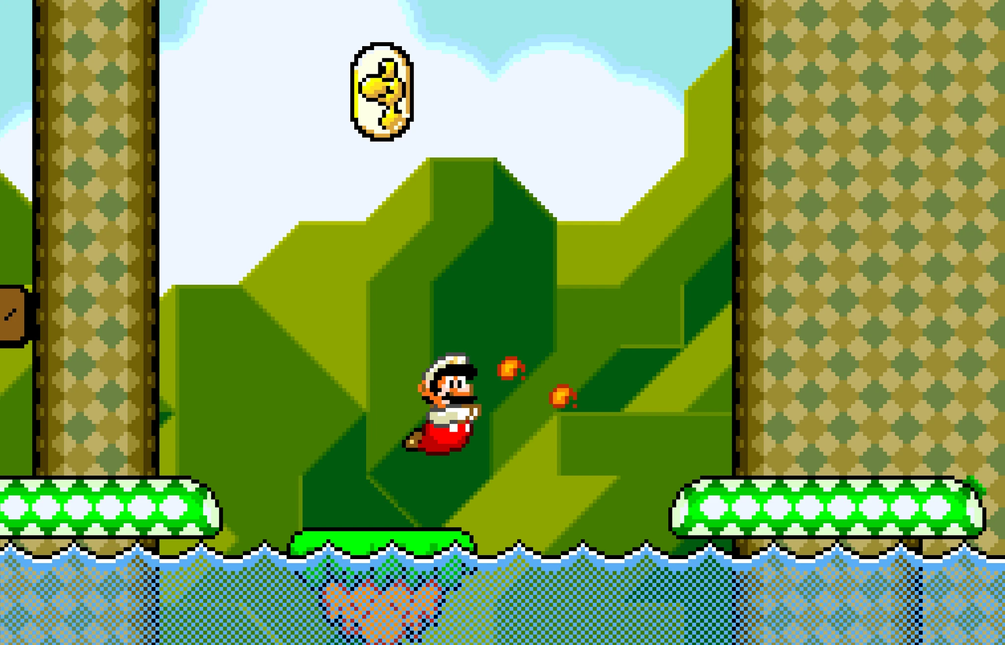 Eldversionen av Mario hoppar över vatten och kastar eldklot i en pixlad bana med gröna kullar, en gul Yoshi-ikon svävar ovanför.