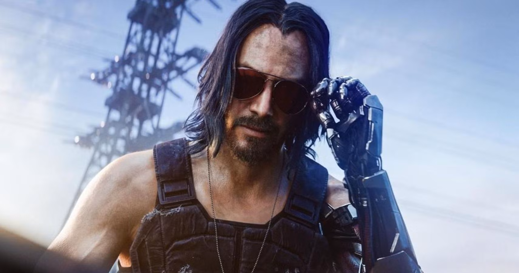 Johnny Silverhand i Cyberpunk 2077 med långt mörkt hår, pilotglasögon och kromad robotarm som han för mot glasögonen framför en elmast.