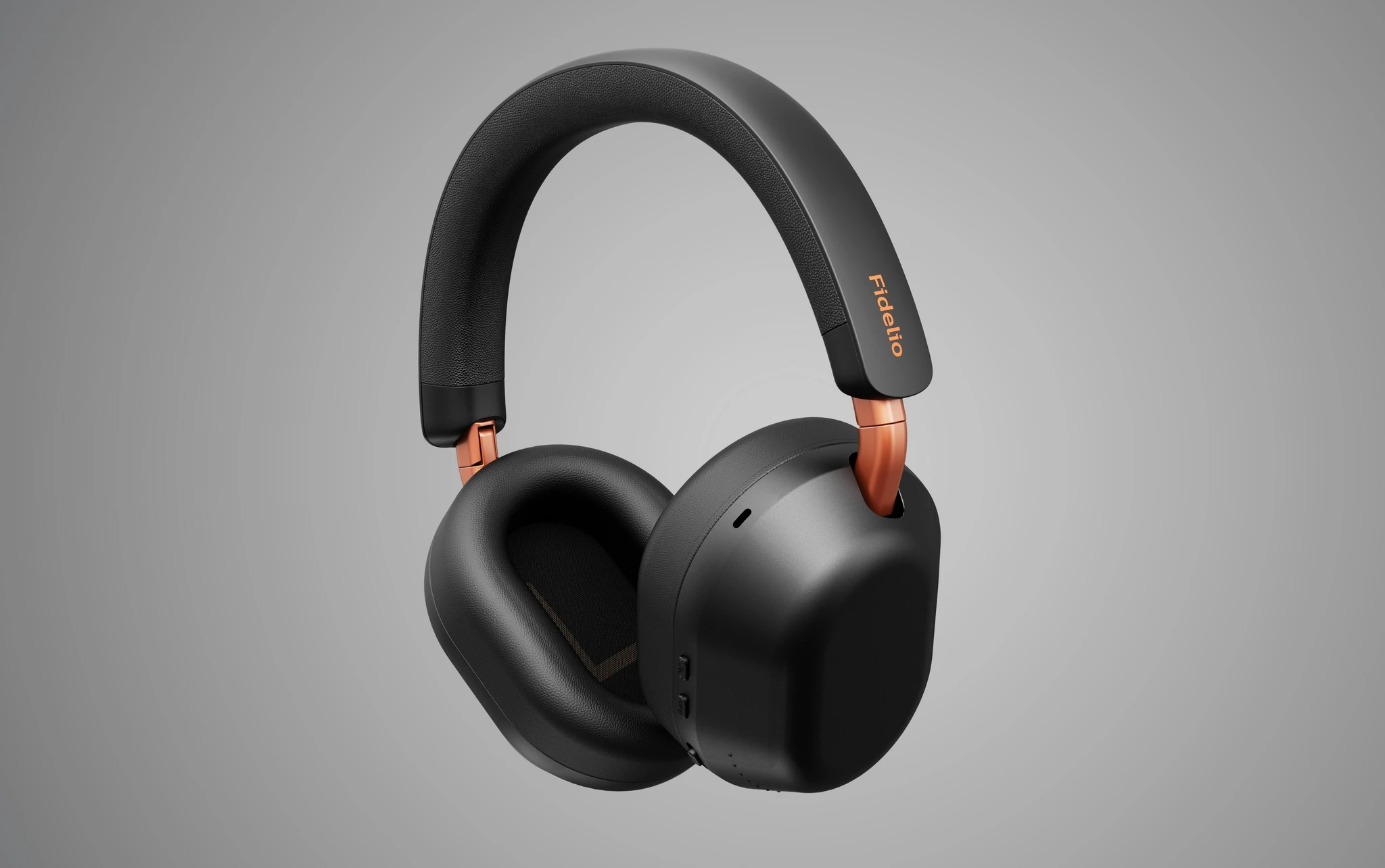 Svarta over-ear-hörlurar från Philips Fidelio med kopparfärgade detaljer vid lederna och namnet på bandet, mot grå bakgrund.